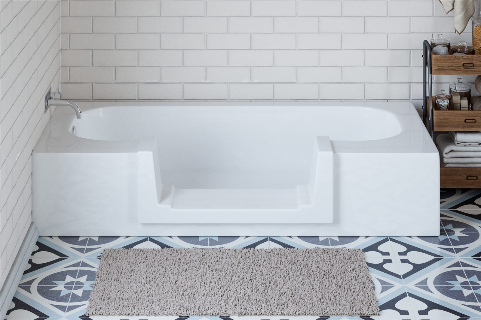 A bathtub converted to a step-in shower with the Quick Tub walk-thru insert, in a tiled bathroom