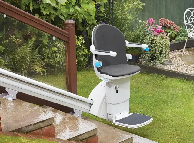A straight stairlift installed on outdoor garden steps